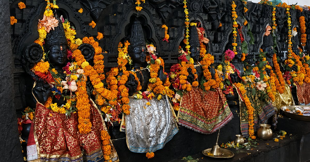 Navagraha deities at Konārka adorned with marigold garlands — the nine planets of Jyotiṣa
